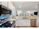 Kitchen features white cabinets, granite counters, and stainless steel appliances at 3019 Fraserburgh Way, Mount Pleasant, SC 29466
