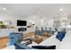 Bright living room features a shiplap accent wall, fireplace, and eat-in kitchen at 3019 Fraserburgh Way, Mount Pleasant, SC 29466