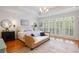 Light-filled main bedroom with wood floors, bench, and ample natural light at 3019 Fraserburgh Way, Mount Pleasant, SC 29466