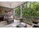 Relaxing screened-in porch with comfortable seating overlooking the serene wooded views at 3019 Fraserburgh Way, Mount Pleasant, SC 29466