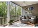 Screened porch with views of the wooded yard offers a relaxing seating area at 3019 Fraserburgh Way, Mount Pleasant, SC 29466