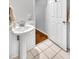 Bright bathroom with a pedestal sink and classic white paneling at 3084 Queensgate Way, Mount Pleasant, SC 29466