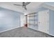 Bedroom features carpet, a ceiling fan, and white doors that add brightness to the space at 3084 Queensgate Way, Mount Pleasant, SC 29466