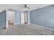 Spacious blue bedroom with neutral carpet, large closet, and ample natural light at 3084 Queensgate Way, Mount Pleasant, SC 29466