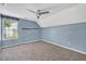 Blue bedroom features neutral carpet, a large window, and a ceiling fan at 3084 Queensgate Way, Mount Pleasant, SC 29466