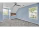 Light blue bedroom features a ceiling fan, gray carpet, and natural light from two windows at 3084 Queensgate Way, Mount Pleasant, SC 29466
