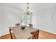 Warm dining area with hardwood floors, chandelier, and a closet for storage at 3084 Queensgate Way, Mount Pleasant, SC 29466