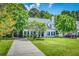 Beautiful home exterior with lush green lawn, mature trees and paved driveway at 3084 Queensgate Way, Mount Pleasant, SC 29466
