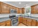 Modern kitchen with stainless steel appliances, granite countertops and wood cabinets at 3084 Queensgate Way, Mount Pleasant, SC 29466