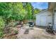 Backyard patio with barbeque, table and chairs surrounded by a wooden fence and lush greenery at 3084 Queensgate Way, Mount Pleasant, SC 29466