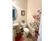 Charming half bathroom with a pedestal sink, decorative floral wall art, and stylish fixtures at 310 Flyway Rd, Goose Creek, SC 29445