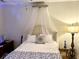 Comfortable bedroom with a bed, neutral walls, canopy, and a decorative lamp at 310 Flyway Rd, Goose Creek, SC 29445