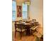 Inviting dining room with wood table set for six, bright light fixture, and natural light at 310 Flyway Rd, Goose Creek, SC 29445