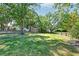 Large backyard with a shed surrounded by mature trees and a well-maintained lawn at 3298 Heathland Way, Mount Pleasant, SC 29466