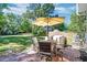 Outdoor patio with furniture and umbrella for relaxing, with a well-maintained backyard and blue sky at 3298 Heathland Way, Mount Pleasant, SC 29466