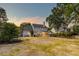 Large backyard with mature trees and landscaping featuring outdoor dining on the patio at 3298 Heathland Way, Mount Pleasant, SC 29466