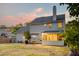 Backyard with a patio, grill, furniture, and a screened-in porch under a colorful dusk sky at 3298 Heathland Way, Mount Pleasant, SC 29466
