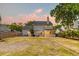 Spacious backyard with a patio, grill, furniture, and a screened-in porch under a colorful dusk sky at 3298 Heathland Way, Mount Pleasant, SC 29466