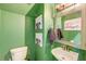 Bathroom with green walls, decorative mirror, and dog portraits on the wall at 3298 Heathland Way, Mount Pleasant, SC 29466