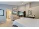 Serene bedroom showcasing ensuite bathroom, TV, artwork and stylish cabinets at 3298 Heathland Way, Mount Pleasant, SC 29466