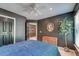 A nice bedroom with hardwood dresser, modern decor, ceiling fan, and access to an attached bathroom at 3298 Heathland Way, Mount Pleasant, SC 29466