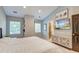 Bright bedroom with lots of light, featuring TV, artwork and a decorative cabinet at 3298 Heathland Way, Mount Pleasant, SC 29466