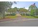 Elegant clubhouse with manicured landscaping and an American flag, showcasing community amenities at 3298 Heathland Way, Mount Pleasant, SC 29466