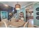 Charming dining room with stylish chandelier, a table for four and stairway to upper level at 3298 Heathland Way, Mount Pleasant, SC 29466