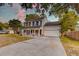 Charming two-story home featuring a welcoming front porch, attached garage, and well-maintained landscaping at 3298 Heathland Way, Mount Pleasant, SC 29466