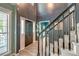 Grand foyer featuring hardwood floors, staircase with black railing, and plenty of natural light at 3298 Heathland Way, Mount Pleasant, SC 29466