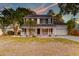 Charming two-story home with a welcoming front porch, lush landscaping, and a well-manicured lawn at 3298 Heathland Way, Mount Pleasant, SC 29466