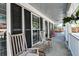 Inviting front porch with rocking chairs, perfect for enjoying the outdoors and neighborhood views at 3298 Heathland Way, Mount Pleasant, SC 29466
