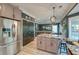 Open kitchen featuring an island, stainless steel refrigerator, and open access to the living room at 3298 Heathland Way, Mount Pleasant, SC 29466