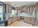 Updated kitchen with stainless steel appliances, floral accents, and stylish backsplash at 3298 Heathland Way, Mount Pleasant, SC 29466