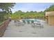 Inviting community pool offers lounge chairs, tables, and shady spots for relaxation in a tranquil tropical setting at 3298 Heathland Way, Mount Pleasant, SC 29466