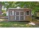 Well-maintained storage shed with double doors and windows, providing ample space for tools and equipment at 3298 Heathland Way, Mount Pleasant, SC 29466