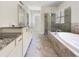 Luxurious bathroom featuring dual vanities, a soaking tub, and a glass-enclosed shower at 350 Oak Park St, Summerville, SC 29486
