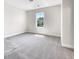 Light-filled bedroom featuring a large window and plush carpeting at 350 Oak Park St, Summerville, SC 29486