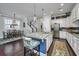 Spacious kitchen featuring an island with seating, white cabinets, stainless steel appliances, and dark wood floors at 3769 Maidstone Dr, Mount Pleasant, SC 29466