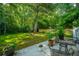 Outdoor patio with seating area, surrounded by greenery and potted plants at 3769 Maidstone Dr, Mount Pleasant, SC 29466