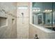 Modern tiled shower with glass door and built-in shelves for storage at 3769 Maidstone Dr, Mount Pleasant, SC 29466