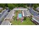 Aerial view of a community with a sparkling pool, lush landscaping, and ample parking at 415 Parkdale Dr # 2F, Charleston, SC 29414