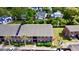 Aerial view of a brick apartment complex with lush green trees, with marshland in the distance at 415 Parkdale Dr # 2F, Charleston, SC 29414