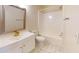 Bright bathroom featuring a shower-tub combo, tiled floors, and a modern white vanity with a large mirror at 415 Parkdale Dr # 2F, Charleston, SC 29414