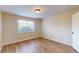 Bright bedroom with wood-look floors, a window for natural light, and a classic white door at 415 Parkdale Dr # 2F, Charleston, SC 29414