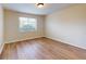 Bright bedroom with wood-look flooring and a window providing natural light and exterior views at 415 Parkdale Dr # 2F, Charleston, SC 29414