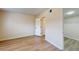 Spacious bedroom with wood-look floors leading to an open door for walk-in closet and bright white trim at 415 Parkdale Dr # 2F, Charleston, SC 29414