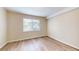 Well-lit bedroom with wood-look flooring and a window offering natural light and neighborhood views at 415 Parkdale Dr # 2F, Charleston, SC 29414