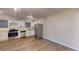 Bright kitchen features stainless steel appliances, white cabinets, and wood-look flooring at 415 Parkdale Dr # 2F, Charleston, SC 29414