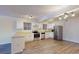 Bright kitchen features stainless steel appliances, white cabinets, and wood-look flooring at 415 Parkdale Dr # 2F, Charleston, SC 29414
